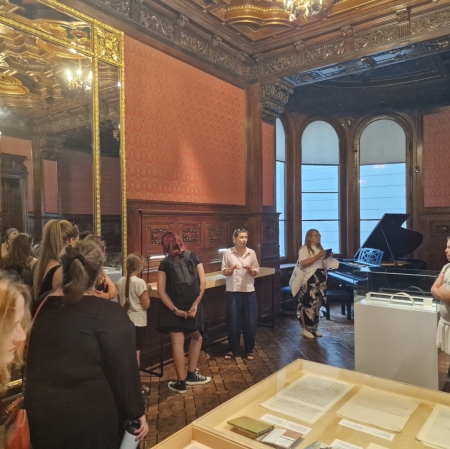 group of people in the Zygmunt Krauze exhibition space. Creative Archive, listening to the educator leading the tour