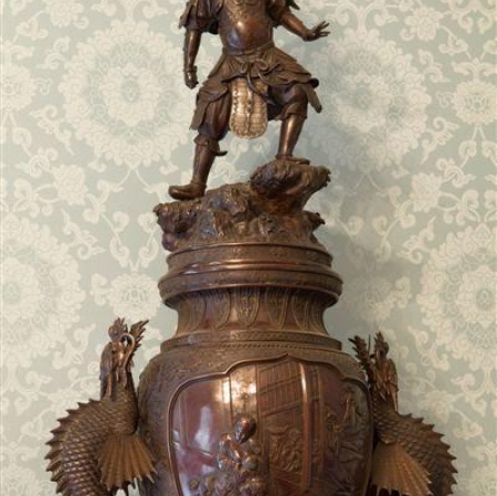 The sculpture is in dark colors