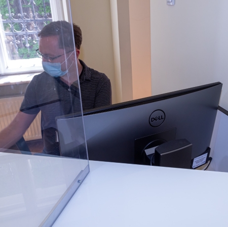 Employee of the Muzeum Sztuki working with computer