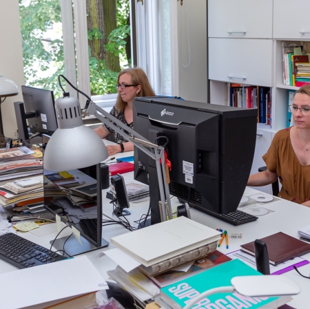 Employees of the Muzeum Sztuki working with computer