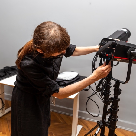 A person working with a photographer's camera