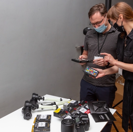 People working with a photographer's camera