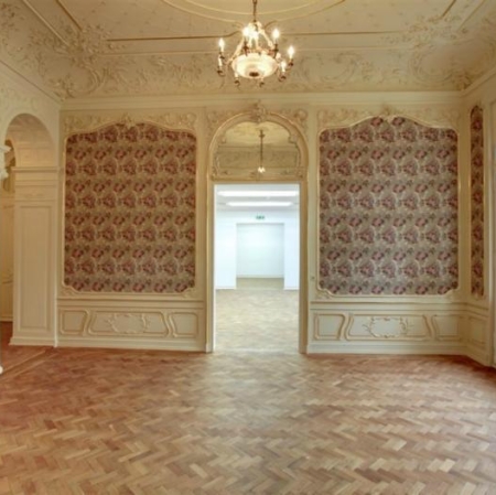 The palace interior is decorated in bright colors with richly decorated walls and ceiling
