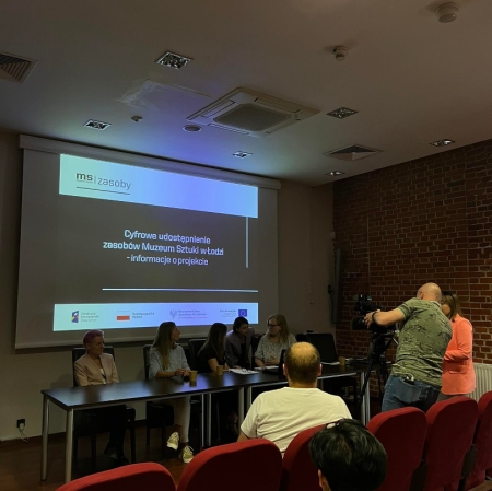 People sitting in the audiovisual room, image from the projector on the wall