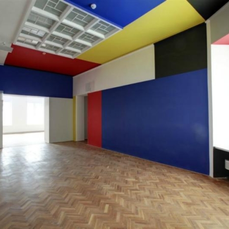 Neoplastic Room, wooden floor, walls painted in blue, red, yellow, white and black