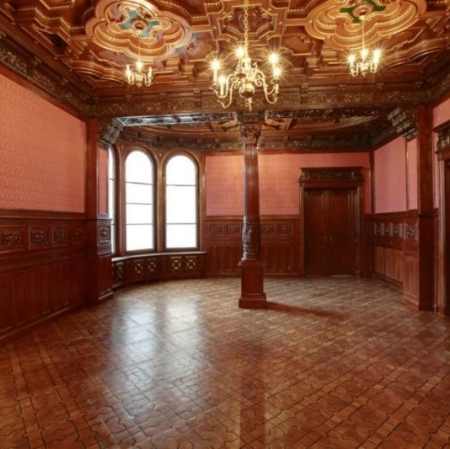 The palace interior is decorated in dark colors, the ceiling and floor are covered with dark wood
