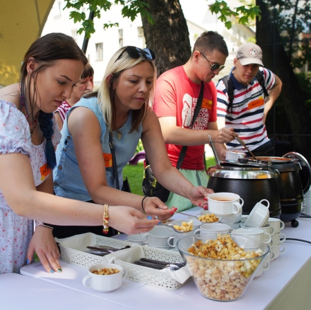 People next to tables with catering