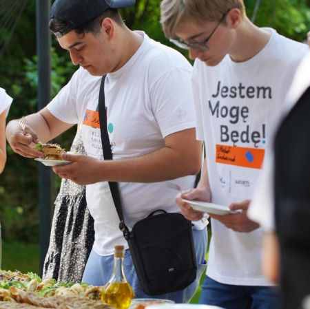 People next to tables with catering