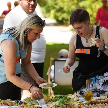 People next to tables with catering