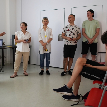 Several people standing in front of the audience