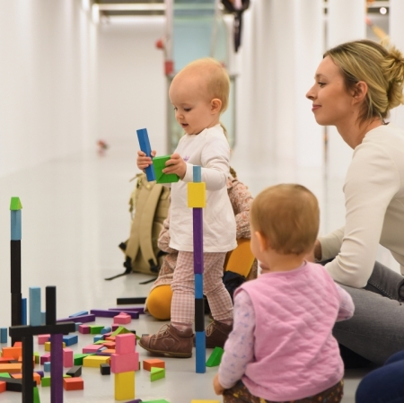 children stacking wooden blocks in the exhibition space