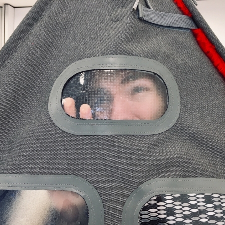 A person looking through a small, transparent hole