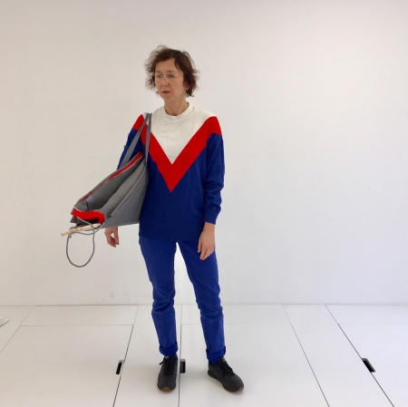 A person standing with an item hanging on his shoulder