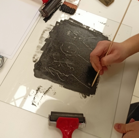 rollers and other monotype tools lying on a white table