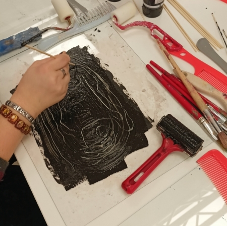 rollers and other monotype tools lying on a white table