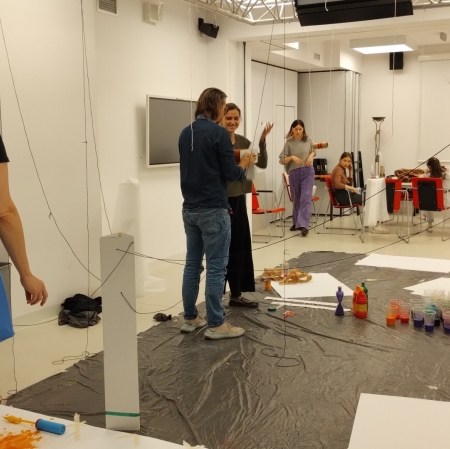 group of people in a workshop room preparing to paint