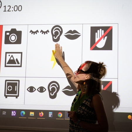 A person showing a projection on the wall