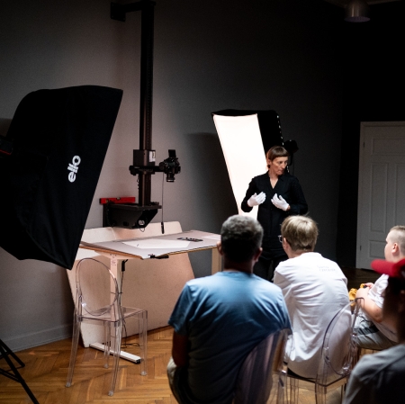People in the digitization workshop, large lamps visible on the sides