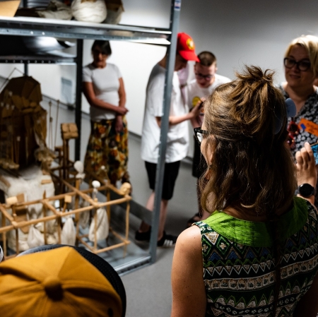 People looking at works of art in a warehouse