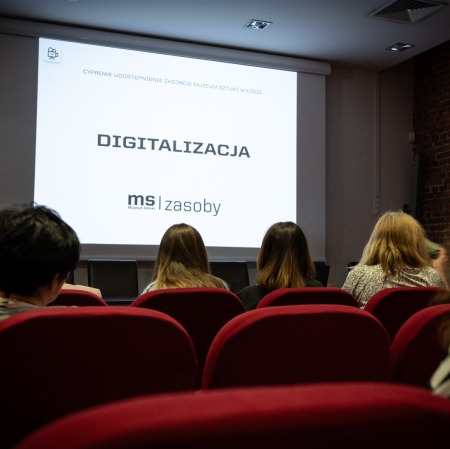 People sitting in the audiovisual room, image from the projector on the wall