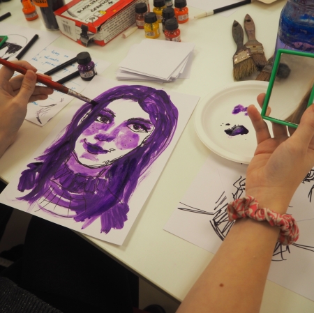 women's hands, a pink eraser on the right wrist, a red brush in the left hand, a portrait of a girl in purple colors on a piece of paper