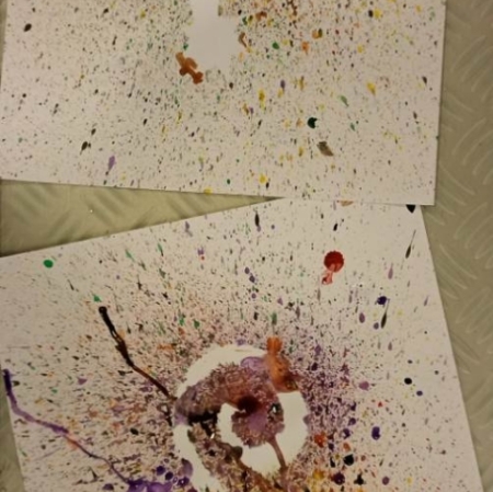 two cardboards with abstract drawings made of various colored spots