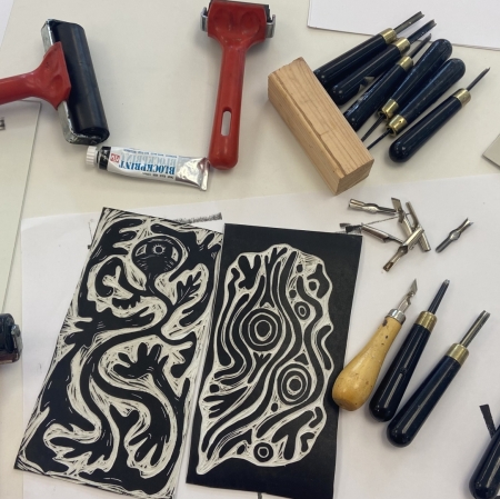 linoleum with previously prepared linocuts, and rollers and chisels placed around