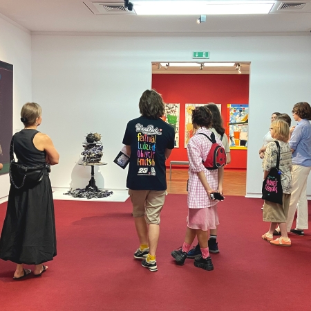 kilka osób w przestrzeni wystawy stojących koło siebie