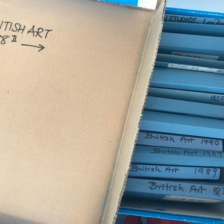 Photo of blue folders inside a cardboard box