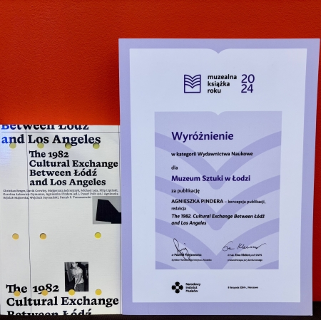 Photo of a book and diploma on a red background