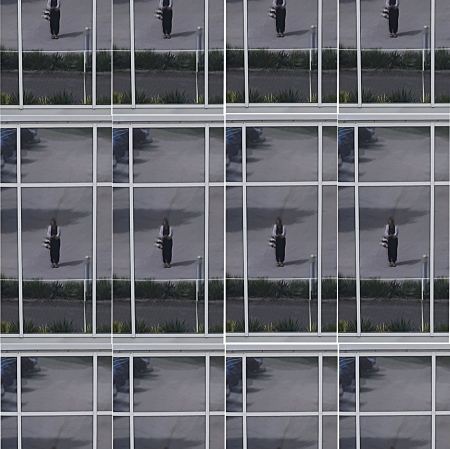 blurred photograph that is a collage, rearranges a person standing on the street, who is in the center of the picture