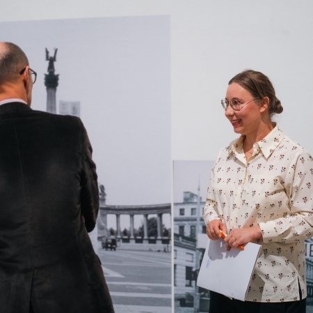 dwie osoby w przestrzeni wystawy, rozmawiają.