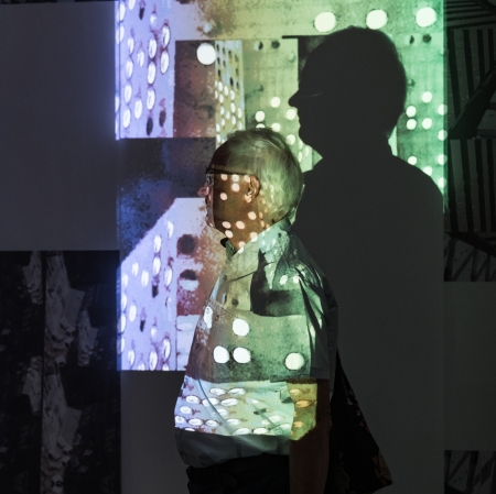 A man's shadow is reflected on the wall. 