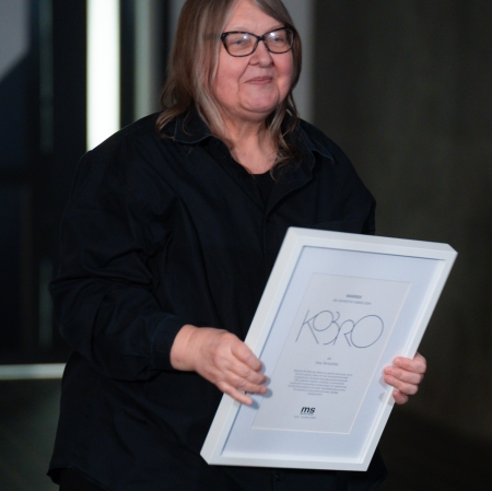 Person holding a white framed diploma in his hands