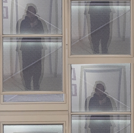 The blurred photograph, which is a collage, depicts a standing figure