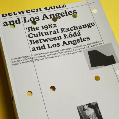White publication with black inscriptions on a yellow background