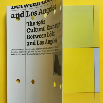 White publication with black inscriptions on a yellow background